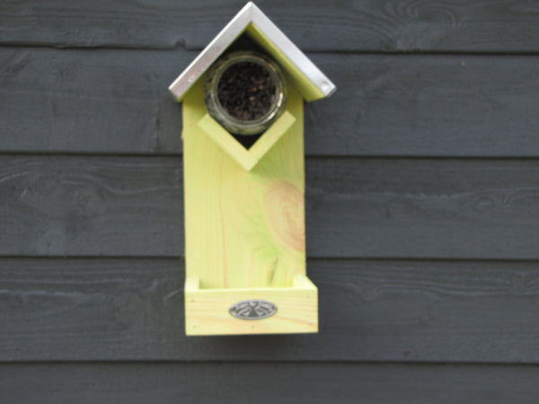 Feeding board with space for both ordinary bird food and peanut butter